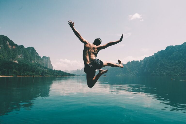 man-jumping-with-joy-by-lake-1.jpg